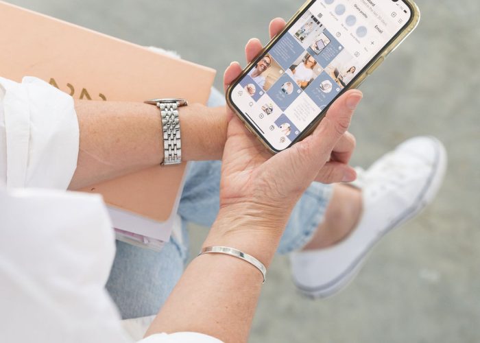 Sarah Hodges holding phone with social media